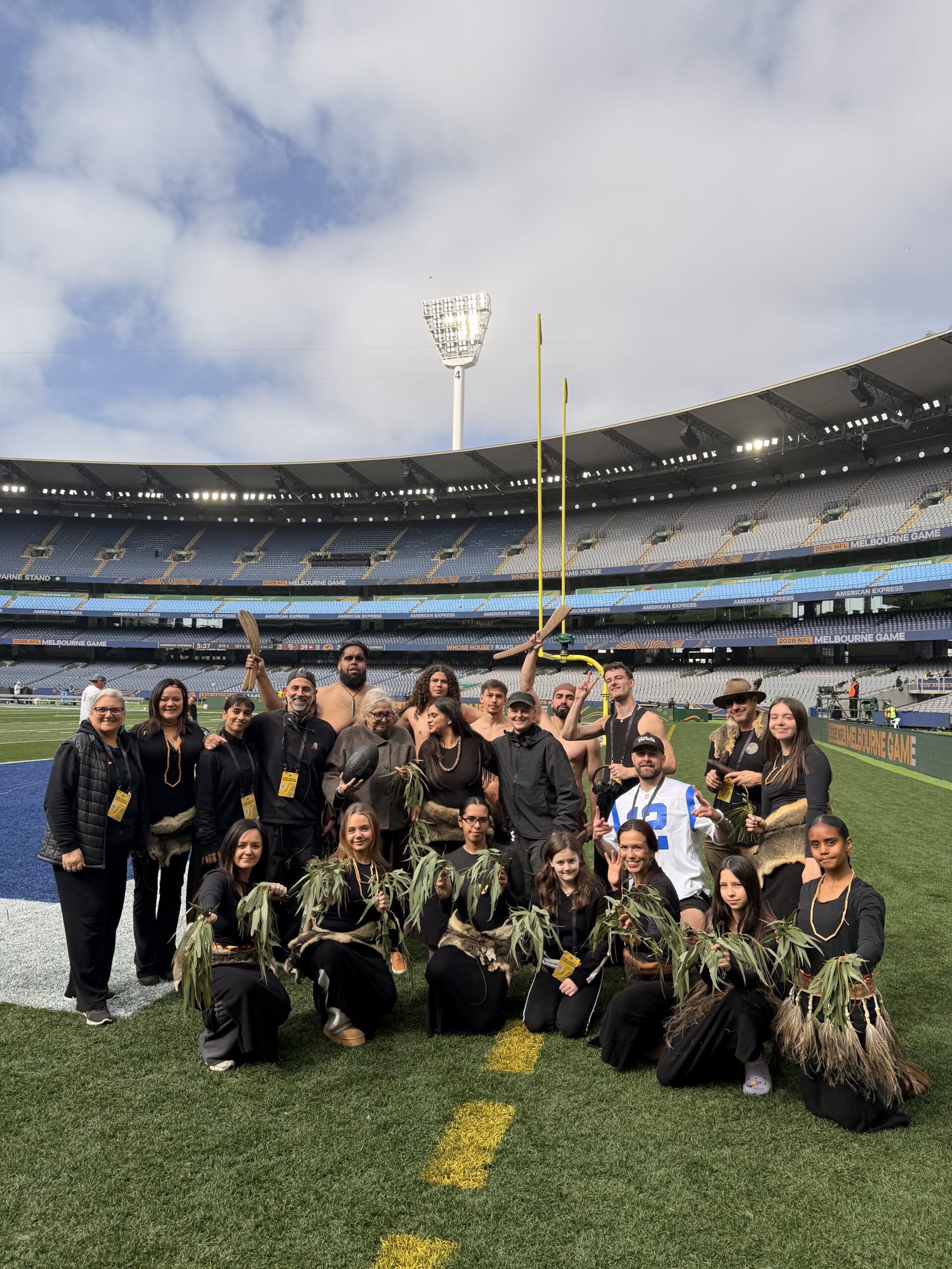 Djirri Djirri dancers, Elders, and family gathered on the MCG pitch during the NFL Melbourne game.